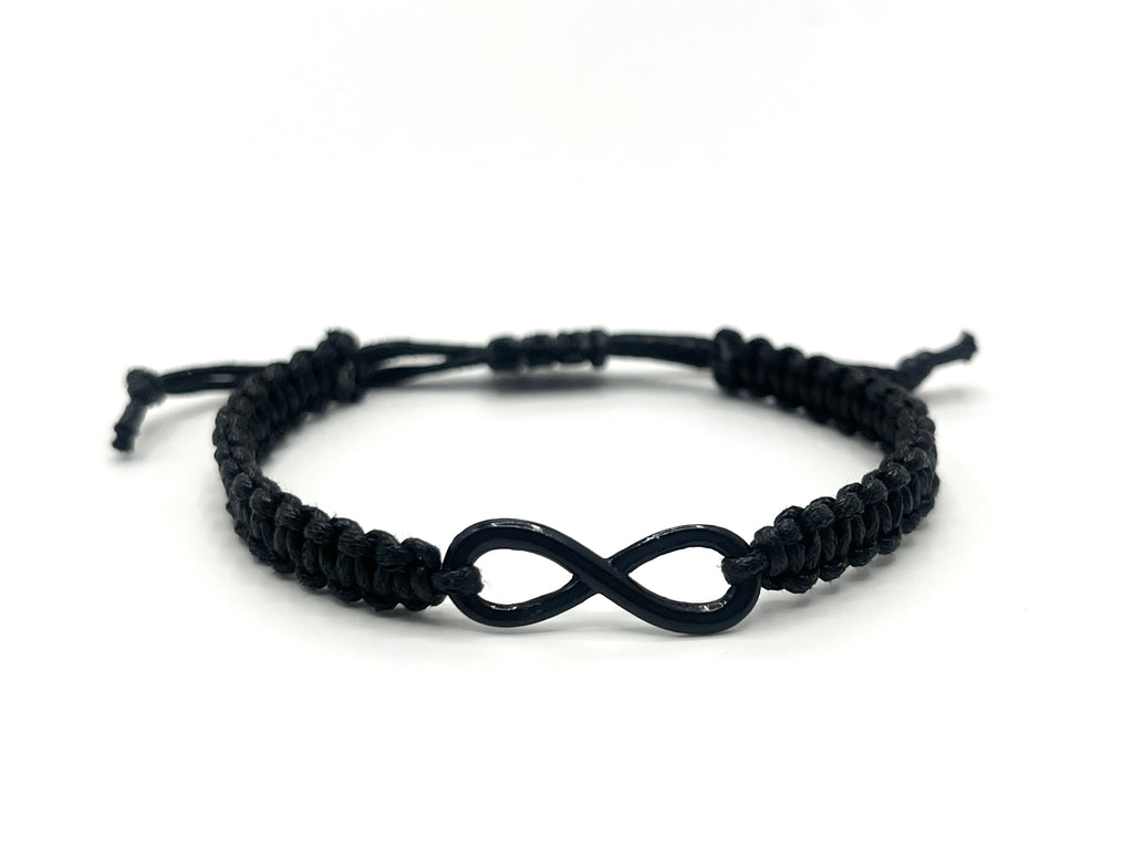 Black macrame bracelet with an infinity symbol on a white background