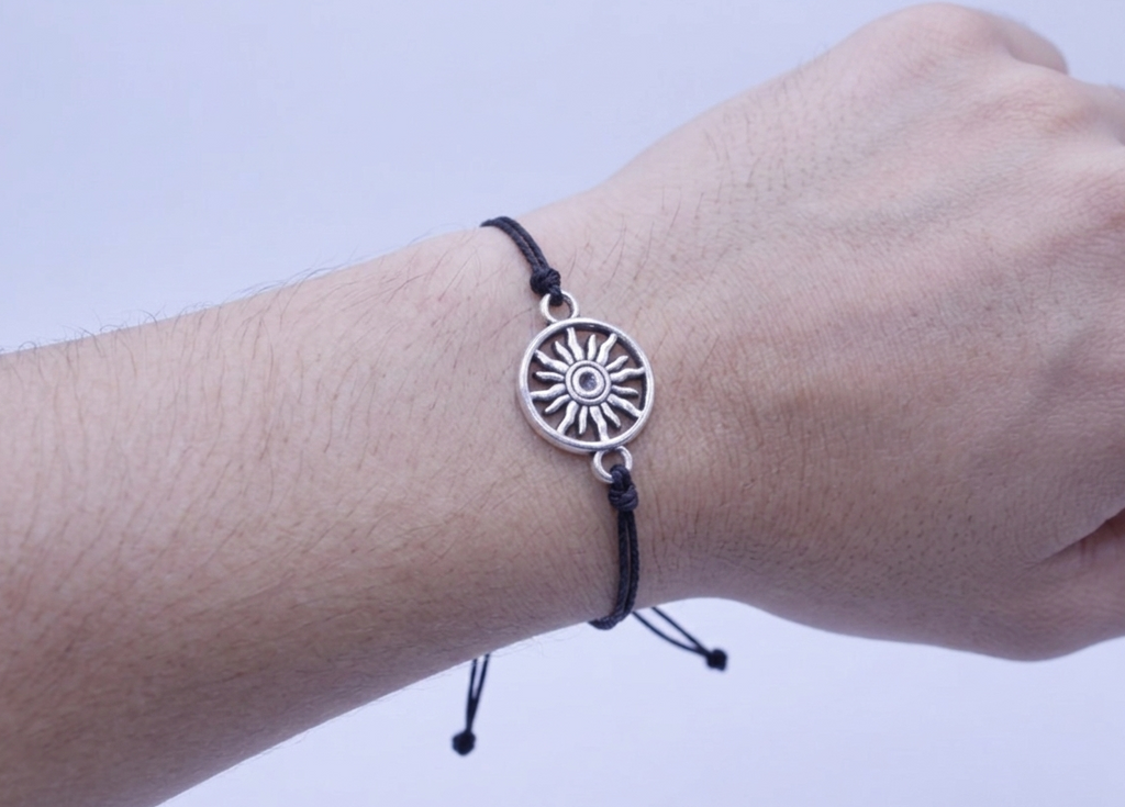 Bracelet with a sun charm on a wrist 