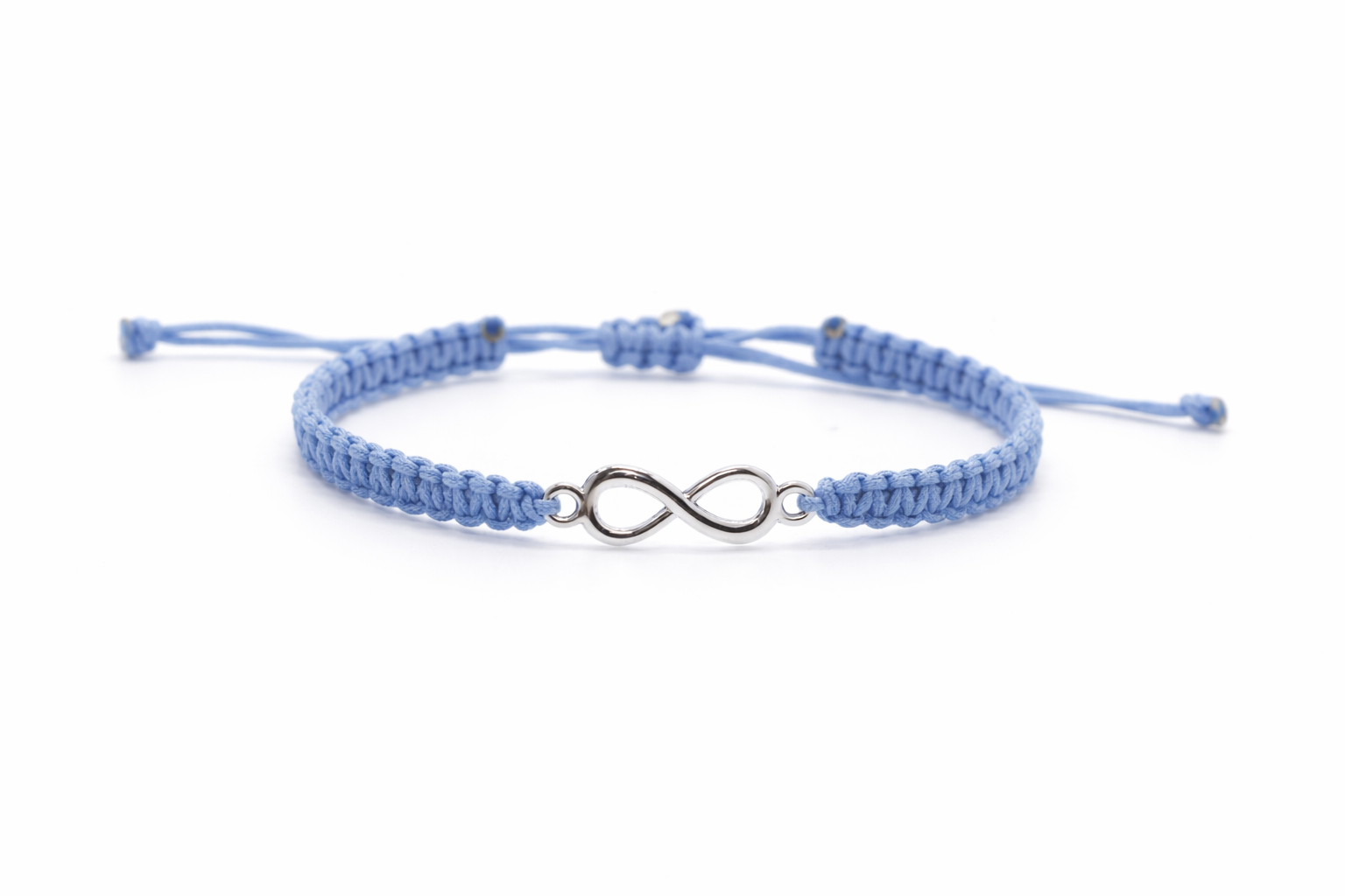 Close-up of infinity charm on handmade macrame bracelet by Chaya