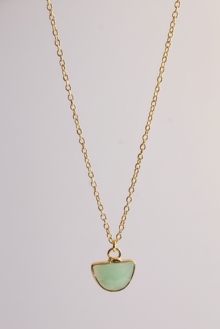 Close up of green aventurine half moon pendant in gold plated