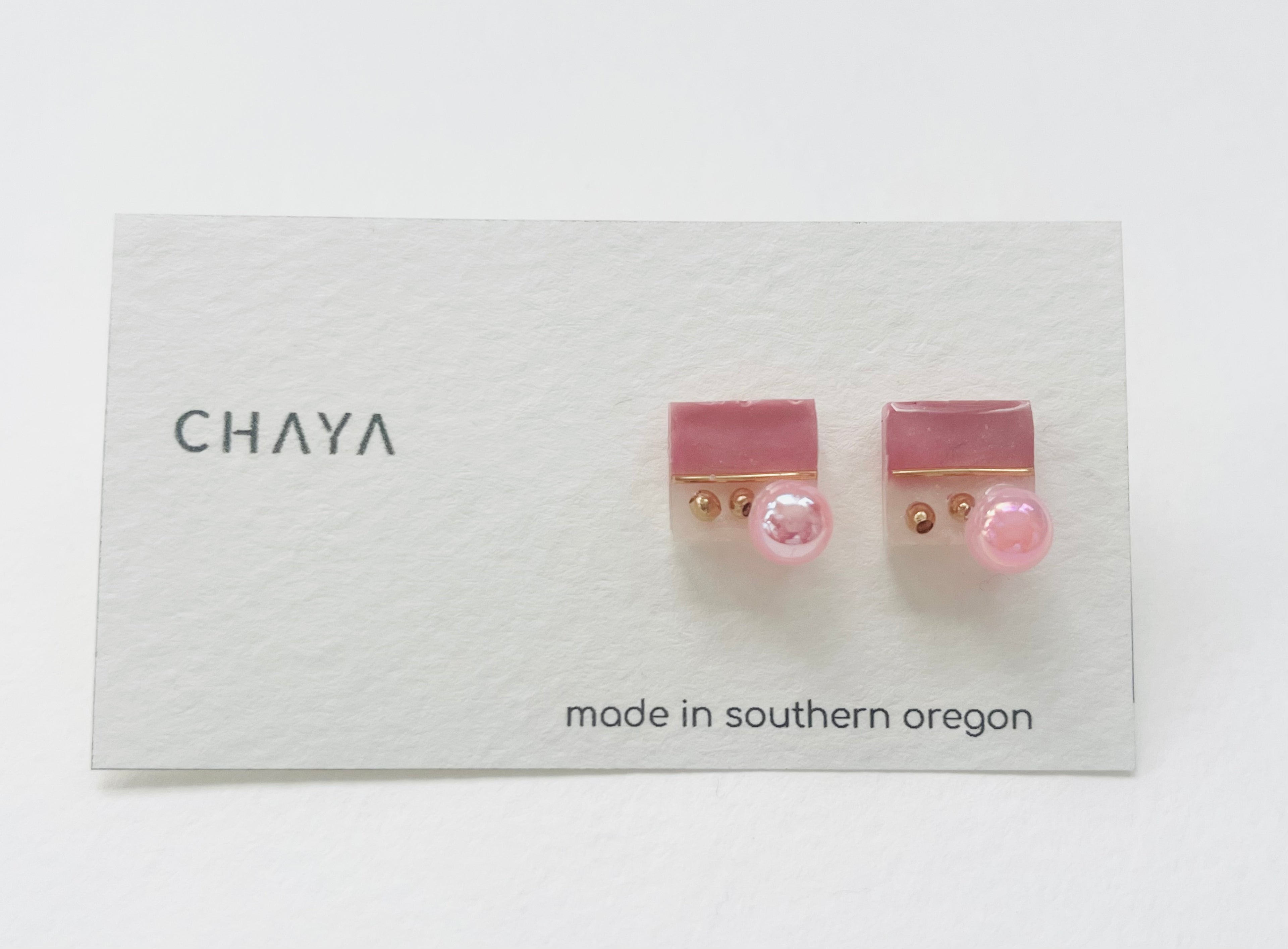 Close up of handmade upcycled resin stud earrings with pearl detail