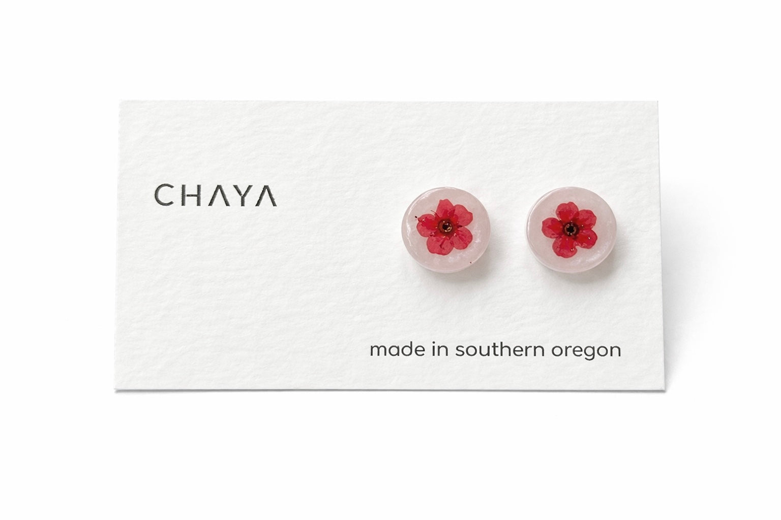 Flower-shaped earrings on a Chaya branded card with 'made in southern Oregon' text.