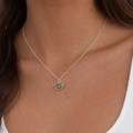 Gold plated green aventurine half moon necklace worn on model, minimalist healing crystal jewelry