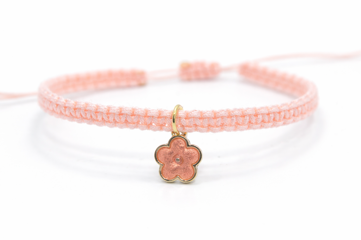 Handmade flower charm bracelet with adjustable cord, boho style on white background