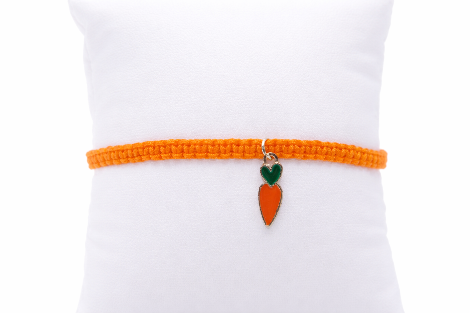 Orange bracelet with a carrot charm on a white background