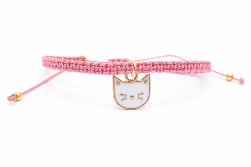 Pink bracelet with a cat charm on a white background