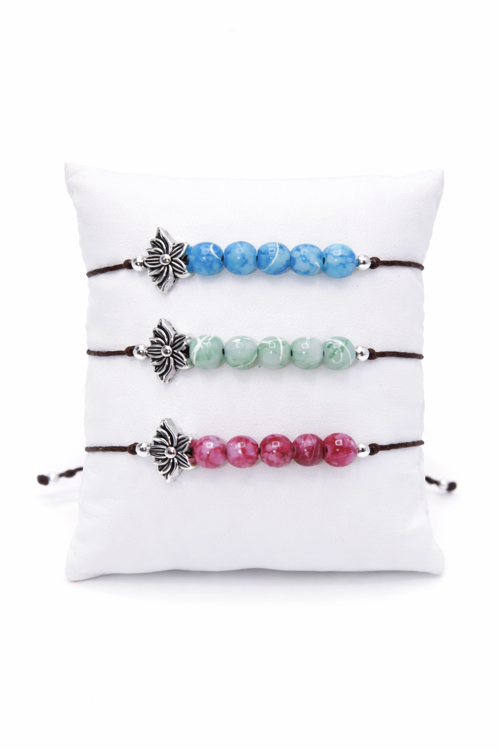 Set of four beaded bracelets with lotus charms