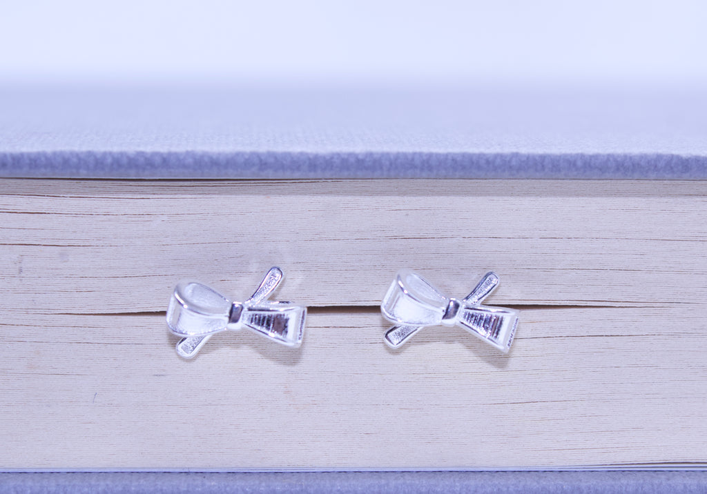 Two clear plastic bows with barcodes on a wooden surface.
