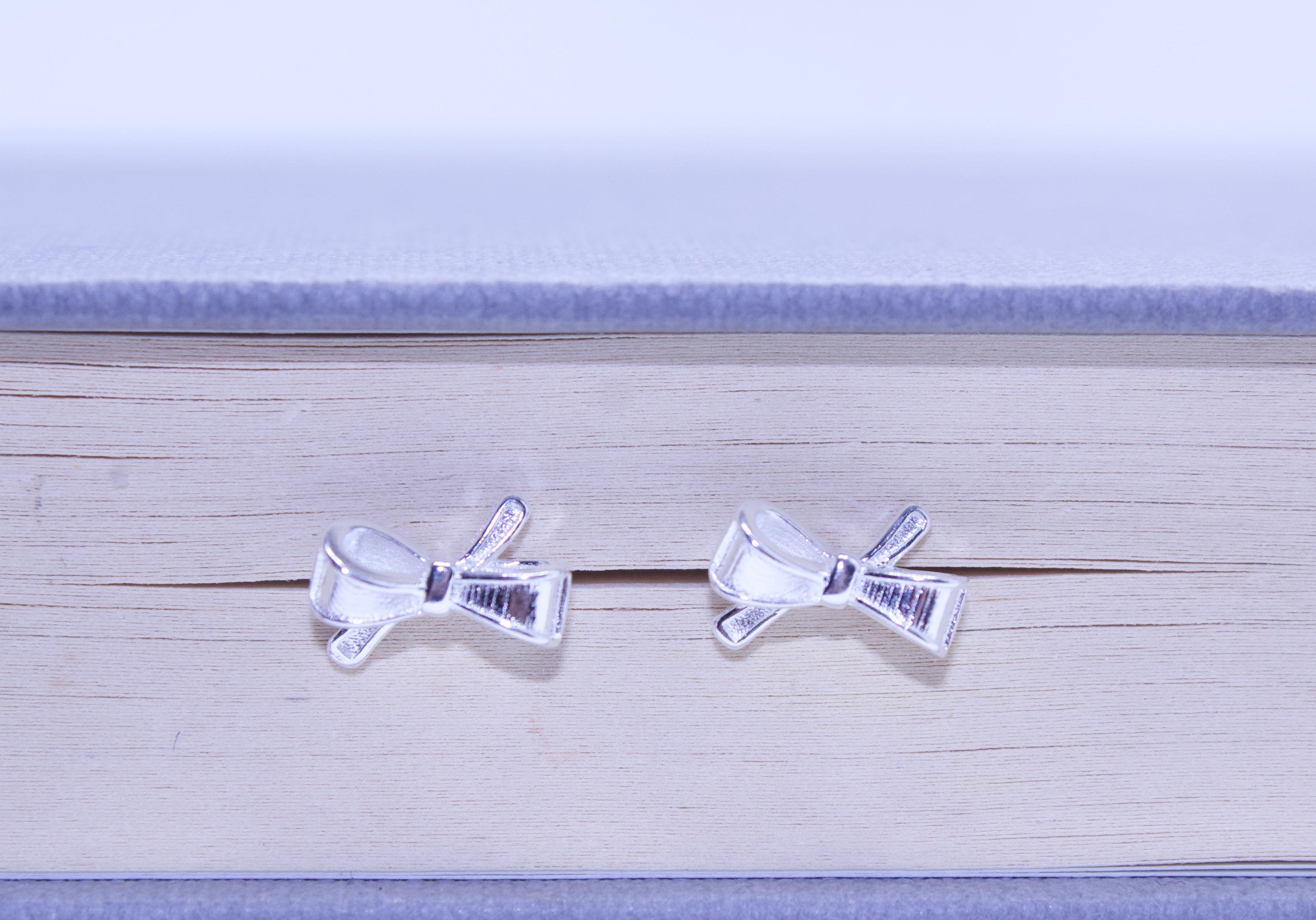 Two clear plastic bows with barcodes on a wooden surface.