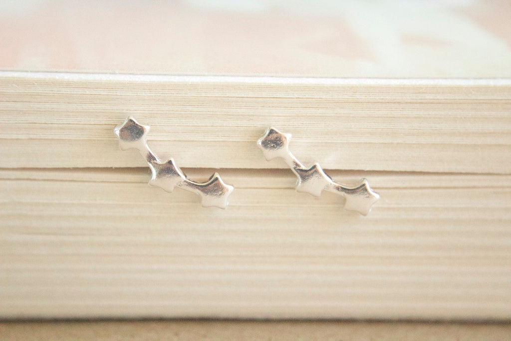 Silver earrings on a wooden surface