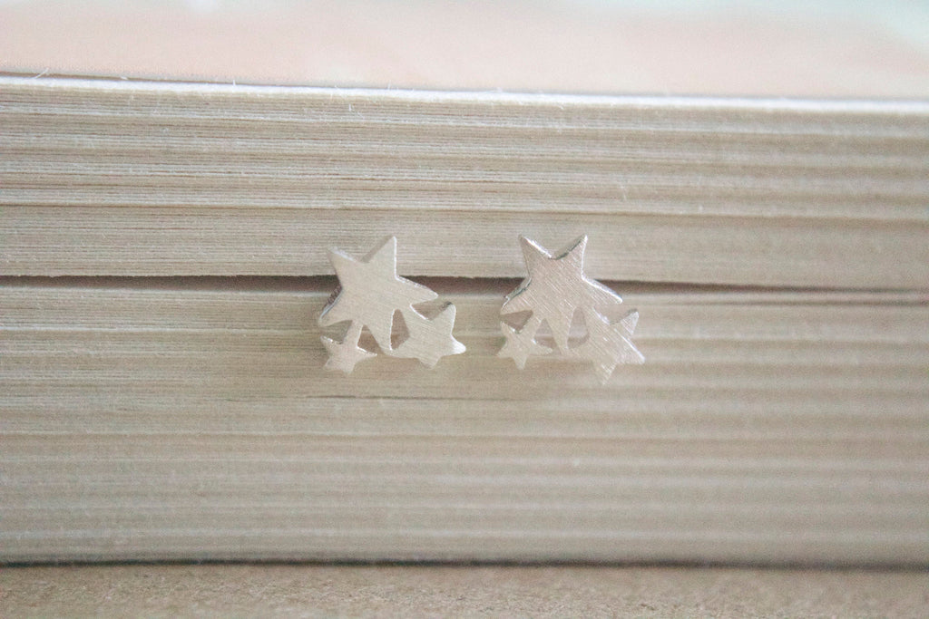 Star-shaped earrings on a textured surface