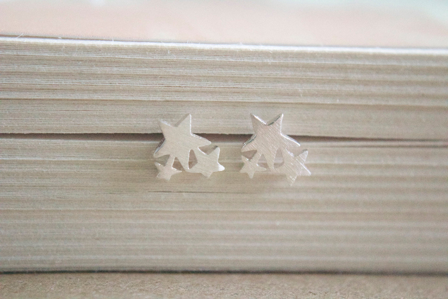Star-shaped earrings on a textured surface