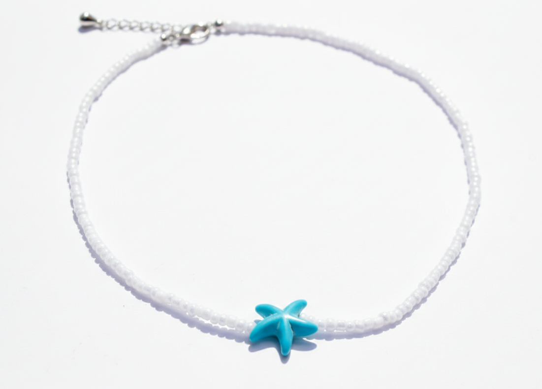 Starfish seed bead necklace laid flat on white background