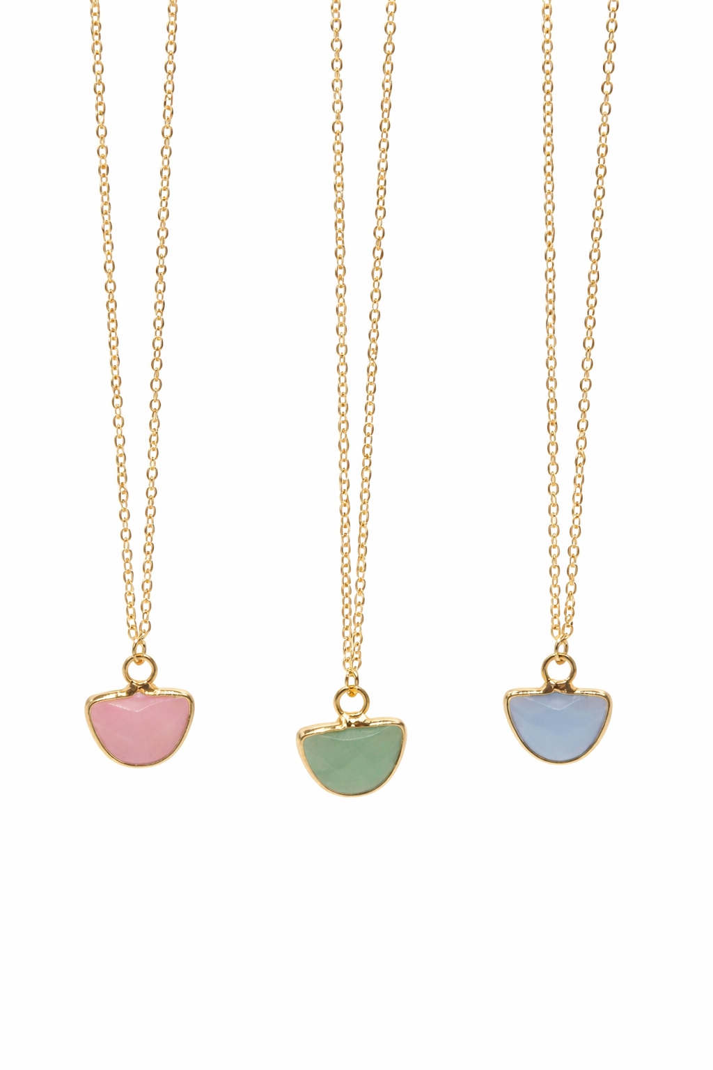 Three gold necklaces with colorful half-circle pendants on a white background