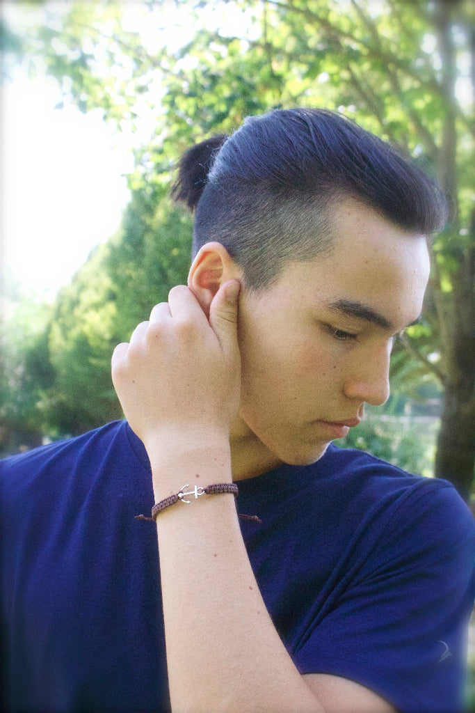 Man with a stylish haircut and blue shirt outdoors