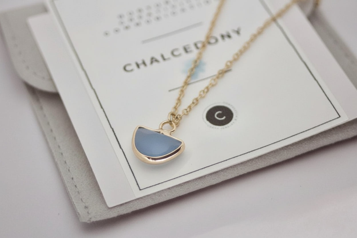 Necklace with a blue pendant on a card labeled 'Chalcedony'