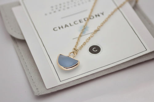 Necklace with a blue pendant on a card labeled 'Chalcedony'