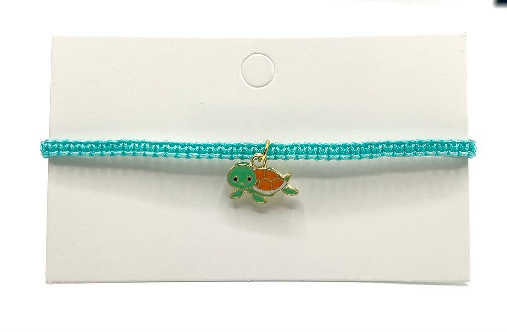 Turquoise bracelet with a turtle charm on a white background