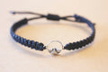 close up mountain charm on handmade macrame bracelet