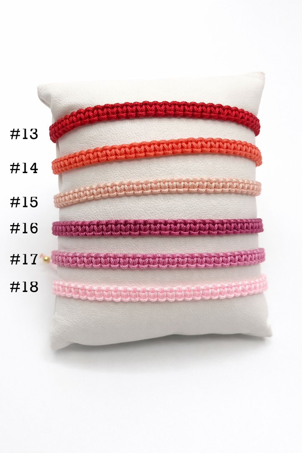 Set of colorful hair ties on a white cushion with numbers indicating their order.