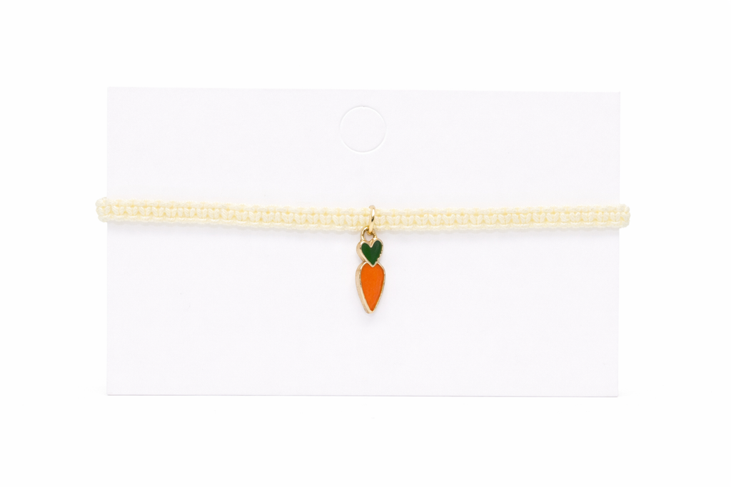 cream bracelet with a carrot-shaped charm on a white background