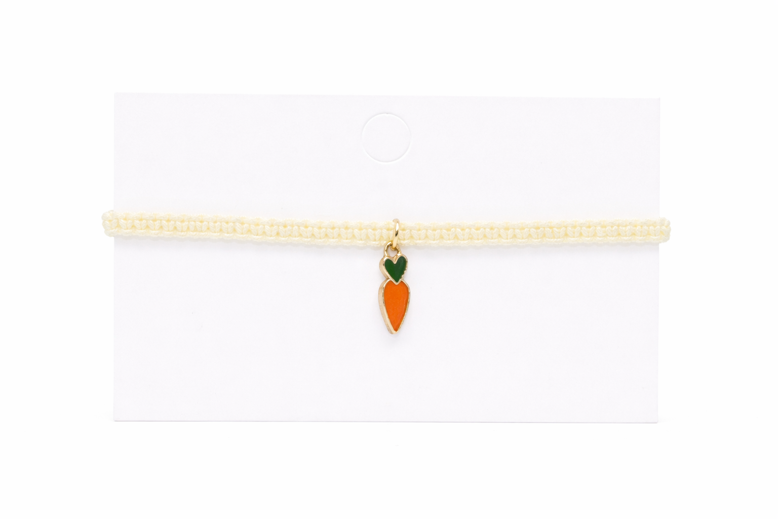 cream bracelet with a carrot-shaped charm on a white background