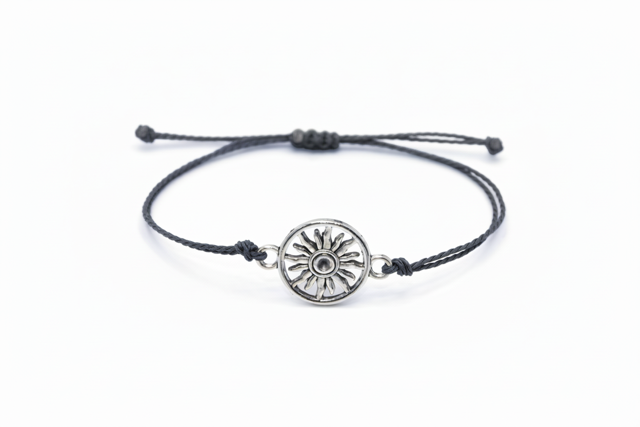 gray bracelet with a silver sun-shaped charm on a white background 