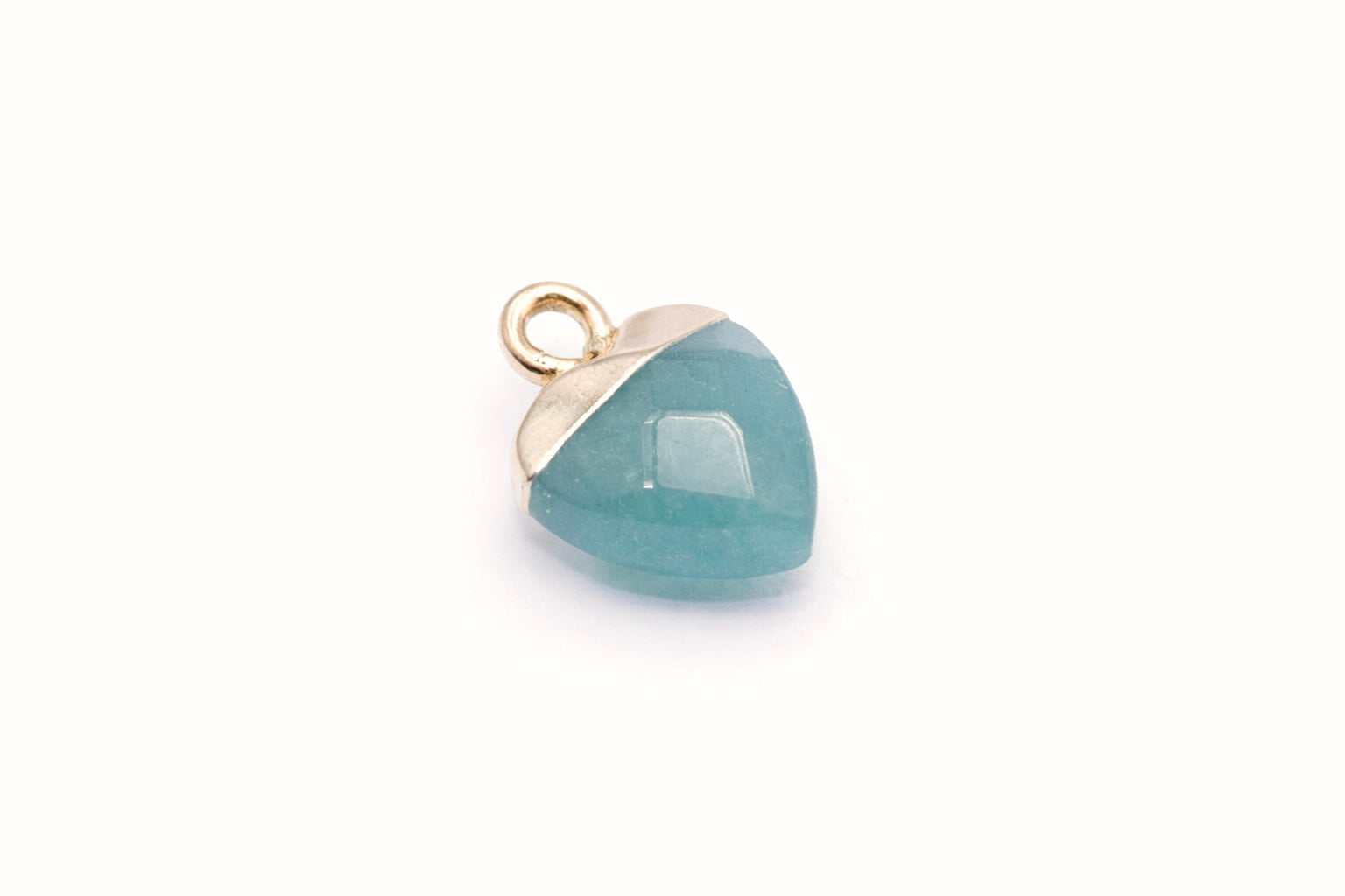 Teardrop-shaped pendant with blue stone and gold edge on a white background