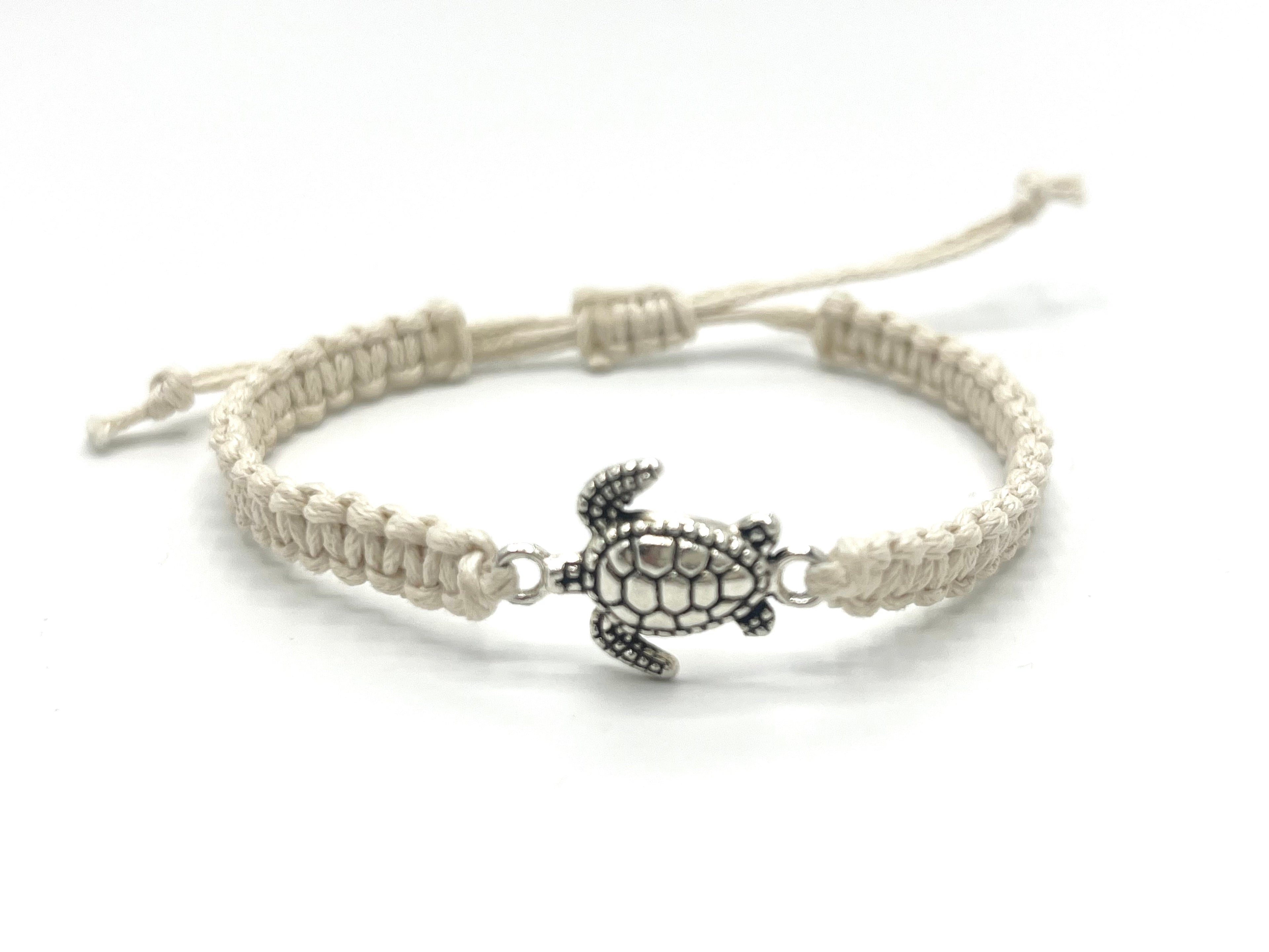 Bracelet with turtle charm on a white background
