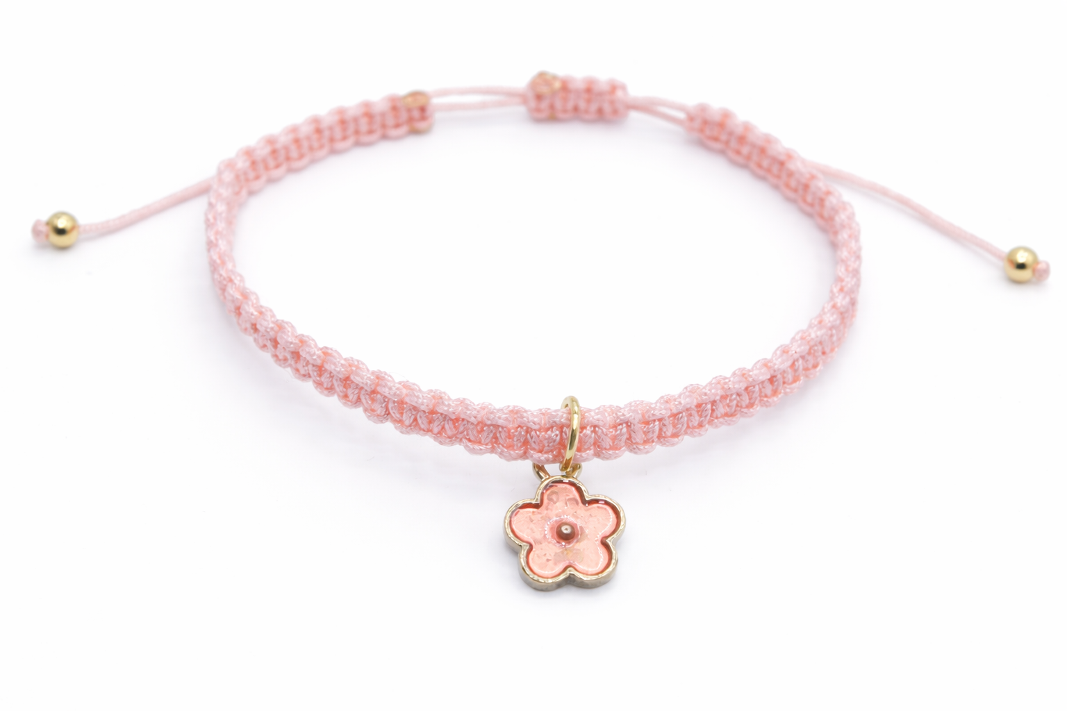 Pink bracelet with a flower charm on a white background