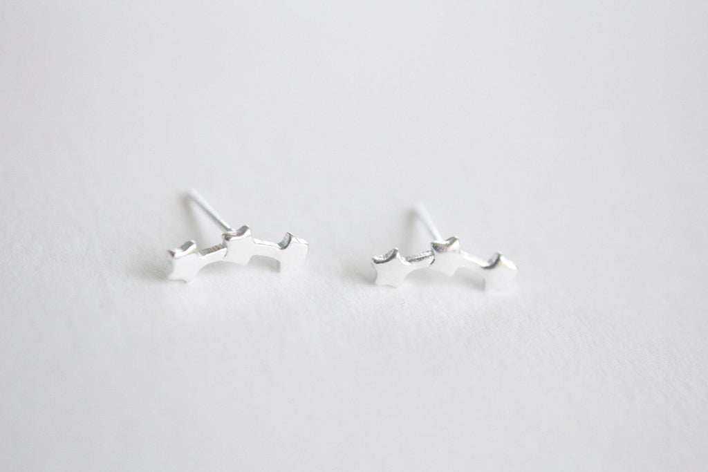 Pair of silver earrings on a light gray background