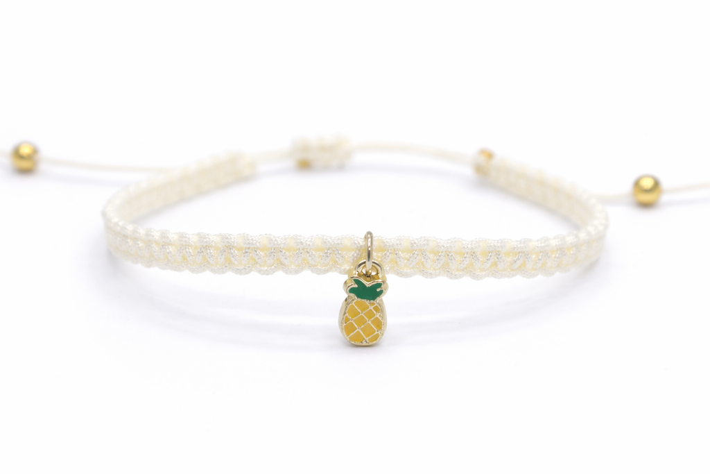 Bracelet with pineapple charm on a white background