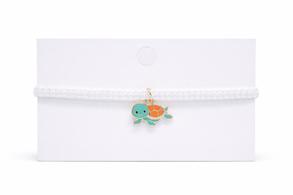 turtle charm on a white card with a white background