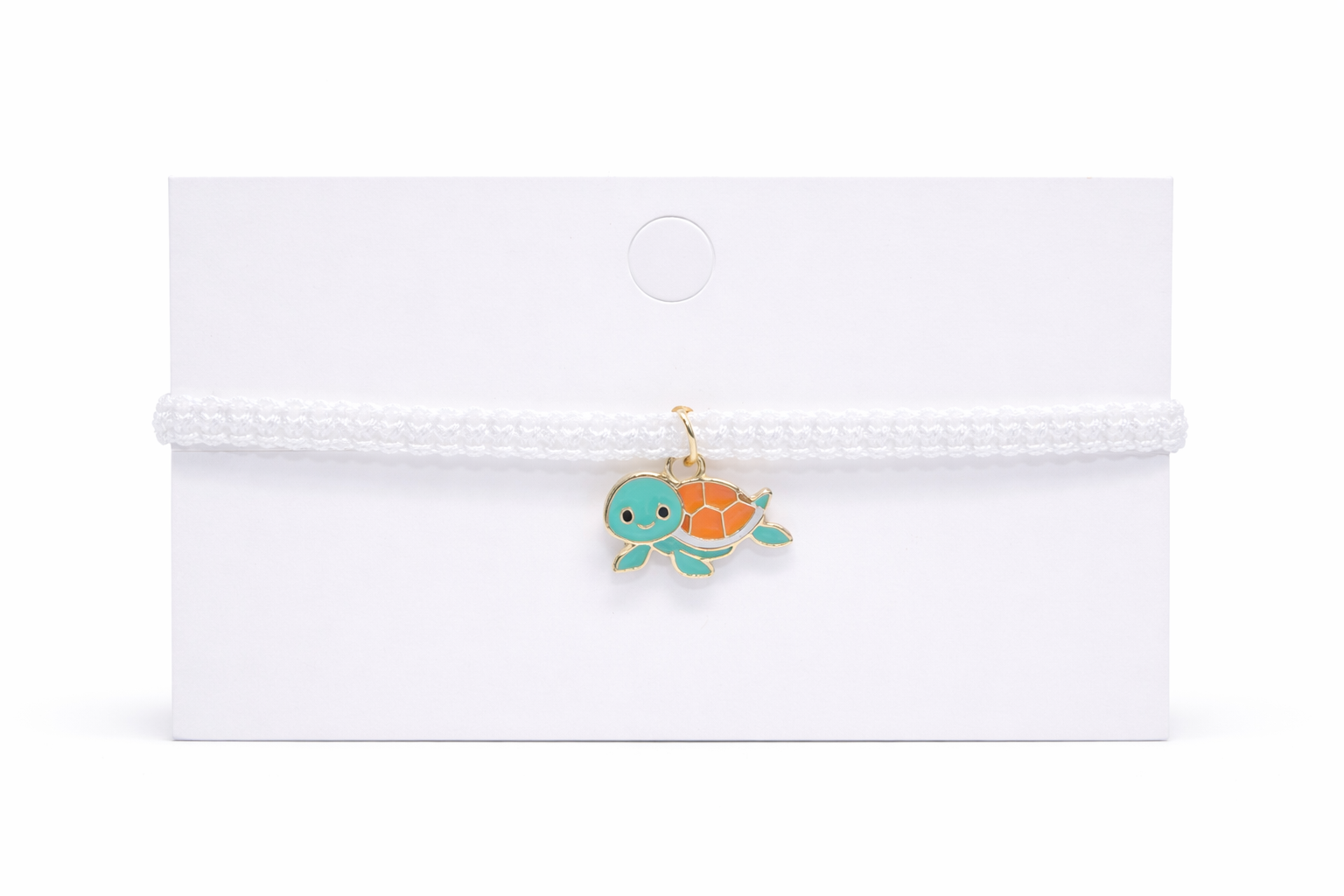 turtle charm on a white card with a white background
