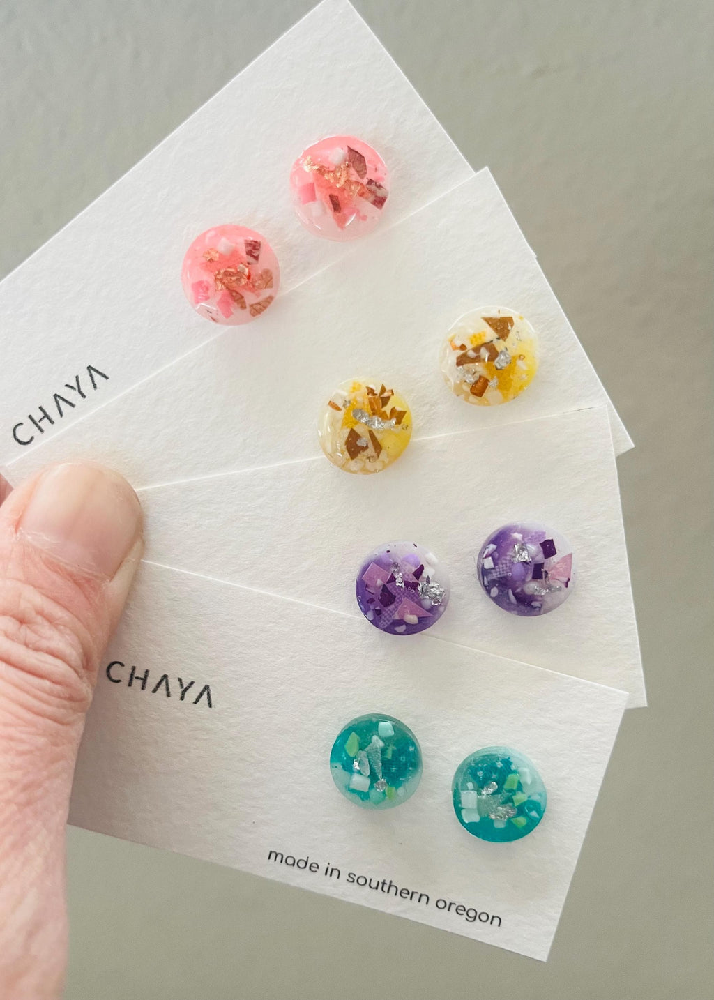 Set of colorful floral earrings on a Chaya branded card.