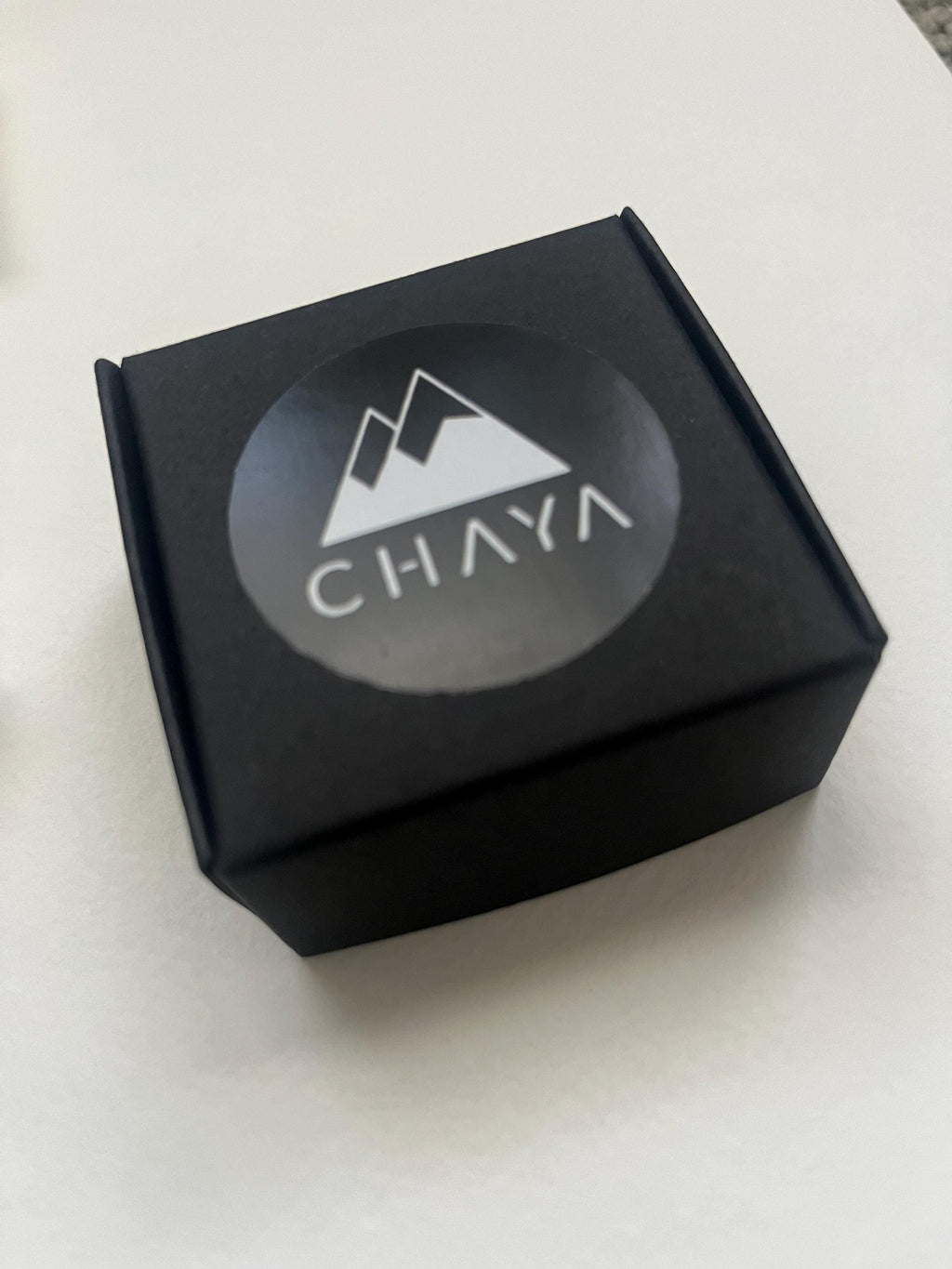 Black box with 'Chaya' logo on a white background