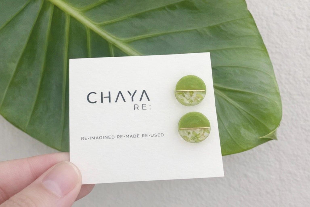 Green circular earrings on a 'Chaya' branded card with a leaf in the background