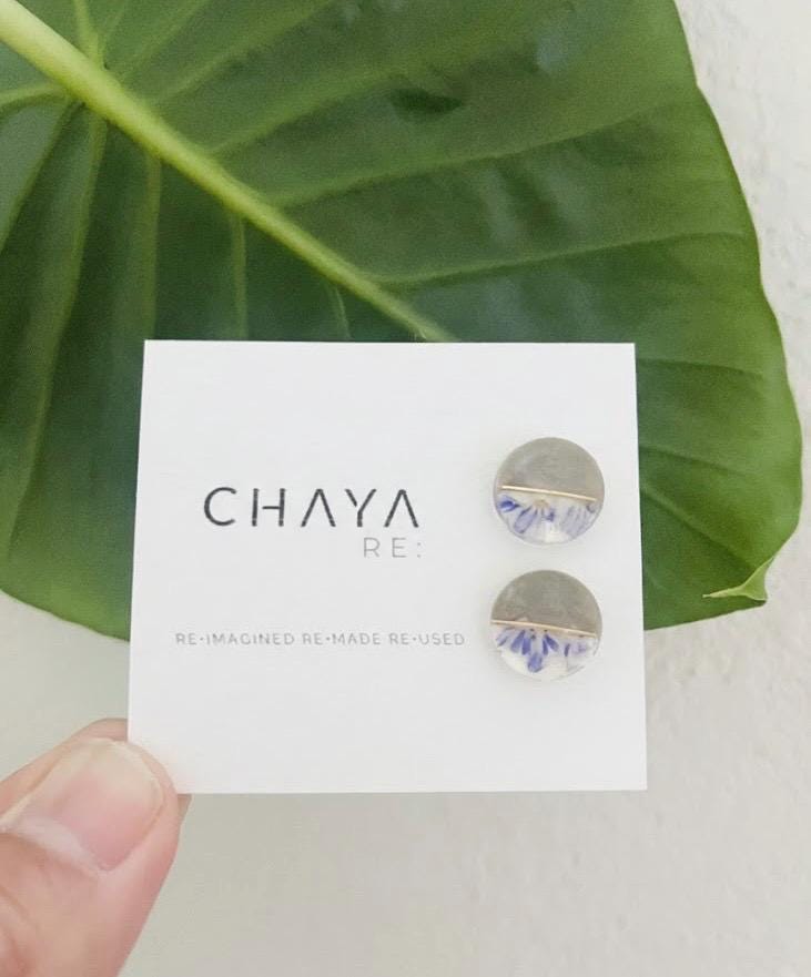 Earrings on a Chaya card with a green leaf background