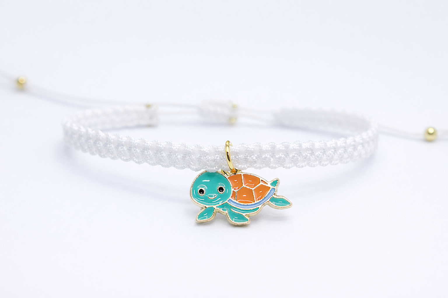 Bracelet with a turtle charm on a white background
